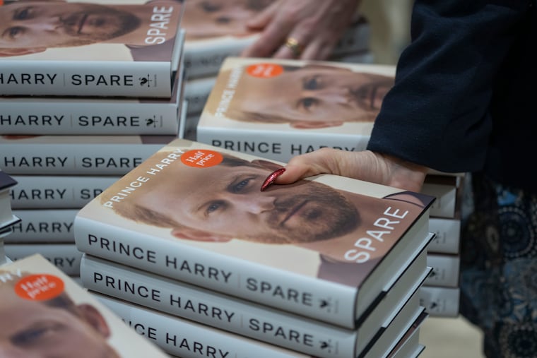 Members of staff place the copies of the new book by Prince Harry called "Spare" at a book store in London on Tuesday, the first day it went on sale. (AP Photo/Kin Cheung)