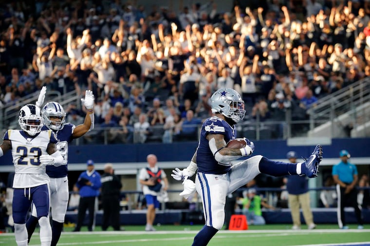 Dallas Cowboys running back Ezekiel Elliott (21) high steps it into the end zone as he scores a a second quarter touchdown against the Los Angeles Rams.