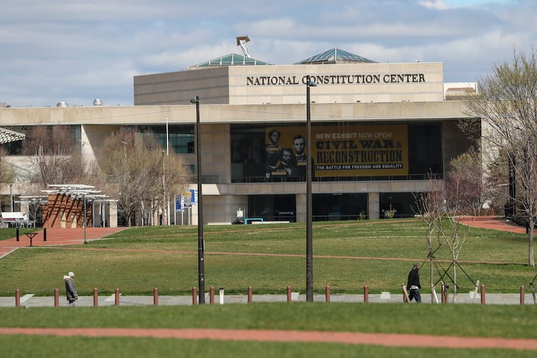 A shuttered National Constitution Center rises over a near empty Independence Mall on March 24, 2020. Non-essential businesses had been closed and a stay-at-home order issued by the city, due to the spread of the coronavirus.