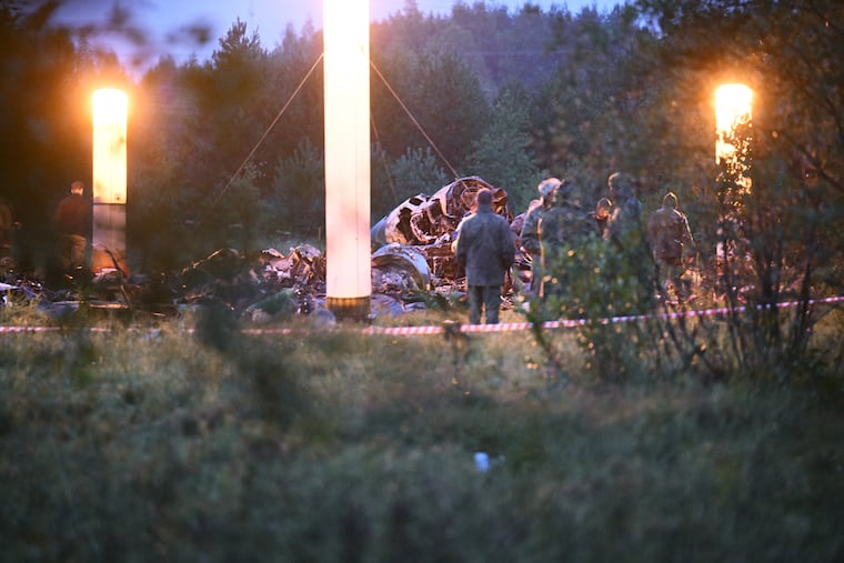 Lamps Illuminate parts of a private jet after a crash near the village of Kuzhenkino, Tver region, Russia, on Thursday.