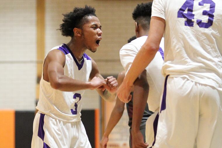 Nasir Lett (left) and Camden teammates celebrate their win over Pleasantville.