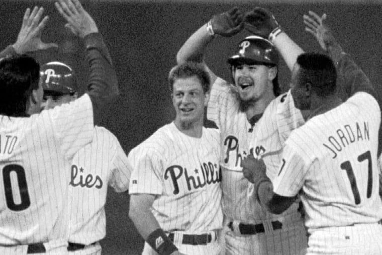 Phillies pitcher Mitch Williams (second from right) celebrates his 10th-inning, game-winning RBI with teammates after defeating the San Diego Padres, 6-5, in the second game of a rain-delayed doubleheader that ended on July 3, 1993.