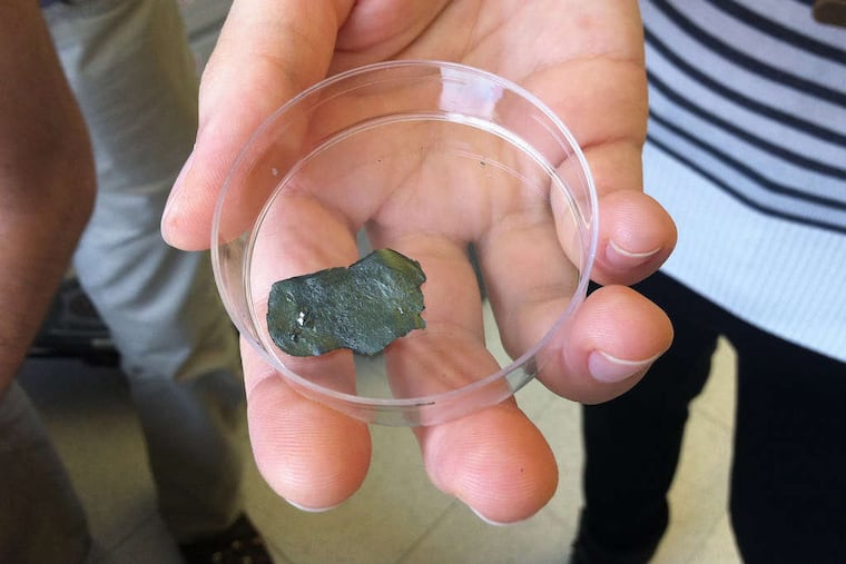 Drexel doctoral engineering students Michael Ghidiu and Maria Lukatskaya helped research a new kind of claylike material that can conduct electricity and store an electrical charge. (TOM AVRIL / Staff)