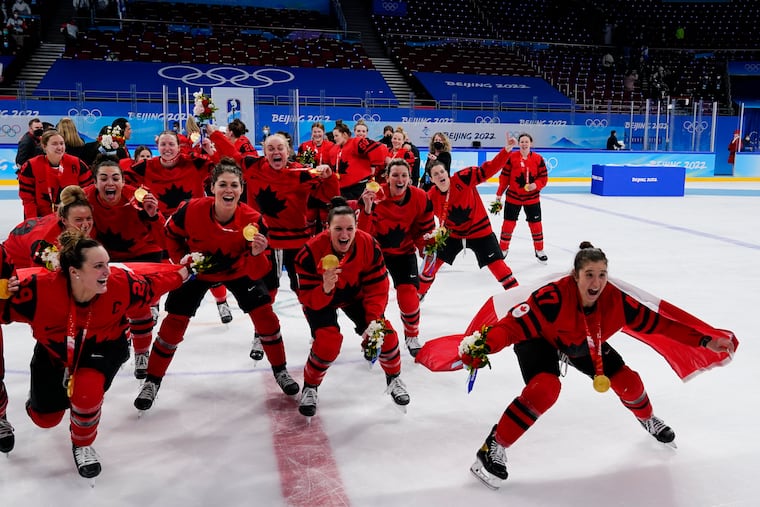 Canada players celebrate with their gold medals.