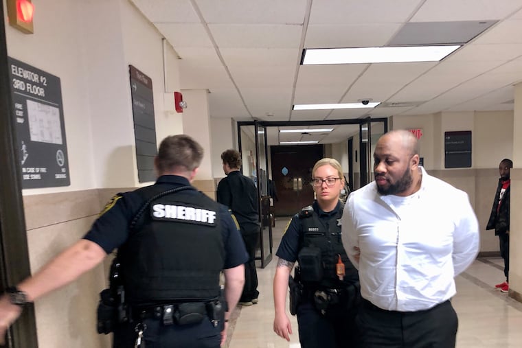 Blair Watts is escorted out of a courtroom in the Montgomery County Courthouse on Wednesday. Watts is charged with first- and third-degree murder in the death of Jennifer Brown, his business partner.