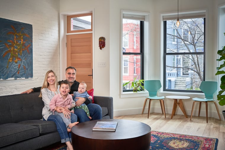 Amy and Jay Hariani with children Ashwin, 3, and Priya, 9 months, in the living room of their Washington, D.C., townhouse.