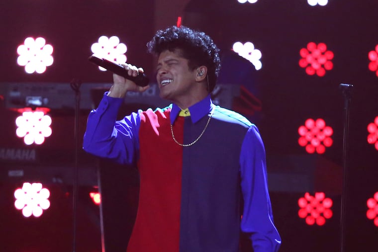 FILE - In this Feb. 22, 2017 file photo, singer Bruno Mars performs on stage at the Brit Awards 2017 in London. Mars may have wrapped up his massive "24K Magic World Tour" last year, but the singer gave one more glimpse into his stellar show the night before the Super Bowl. Some concertgoers danced down the aisles, others threw their hands up high and the majority recited Mars' lyrics at the Bud Light Super Bowl Music Fest on Saturday night, Feb. 2, 2019, in Atlanta. (Photo by Joel Ryan/Invision/AP, file)