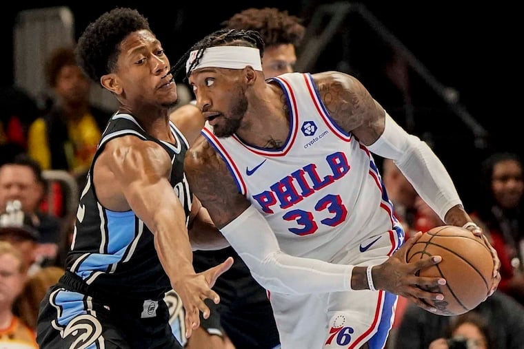 Sixers forward Robert Covington (33) drives against Hawks forward De'Andre Hunter during the first half Friday. Covington stuffed the stat sheet with eight points, three rebounds, two assists, a steal, and two blocks.