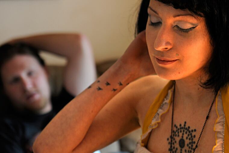 Anomie Fatale at home in Bellmawr with her boyfriend and bandmate, Jesse Draham. The pair, who are working on a CD, met at an open-mic night. TOM GRALISH / Staff Photographer