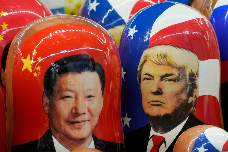 Traditional Russian wooden dolls called Matryoshka depicting China's President Xi Jinping, left, and U.S. President Donald Trump are on sale at a souvenir shop in St. Petersburg, Russia, on Nov. 21, 2024.