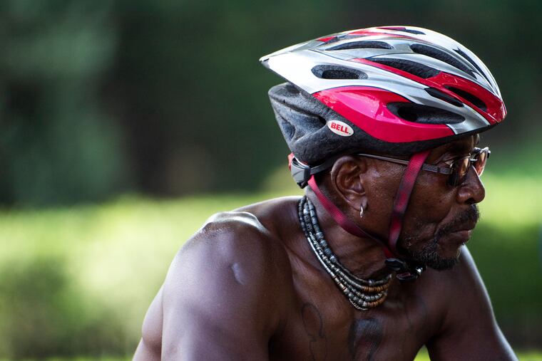 A biker rides along Kelly Drive in Philadelphia during the heat on Thursday.
