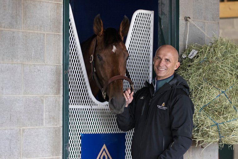 Terry Finley part-owner of Flightline, with the colt, at Keeneland Race Course in Lexington, Ky. Flightline is preparing for the Breeders' Cup Classic at Keeneland, where the undefeated colt is expected to be heavily favored.