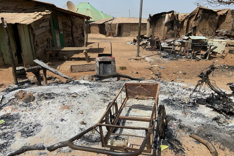 Burned homes and tools stand on an ash covered ground, days after an attack in the village of Woro, Nigeria, Thursday, Feb. 5, 2026.