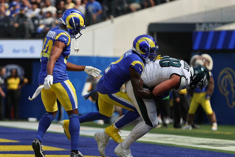 Eagles tight end Dallas Goedert catches a first quarter touchdown against Los Angeles Rams safety Russ Yeast (center) and cornerback Ahkello Witherspoon at SoFi Stadium in Inglewood, California on Sunday, Oct. 8, 2023.