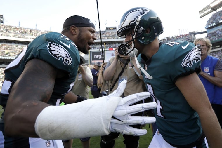 Linebacker Najee Goode, and Jake Elliott celebrate after Elliott’s game-winning field goal.