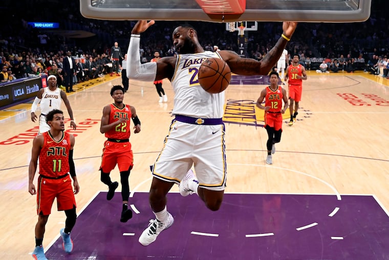 The Lakers’ LeBron James (23) dunking against the Atlanta Hawks during the first half Sunday.