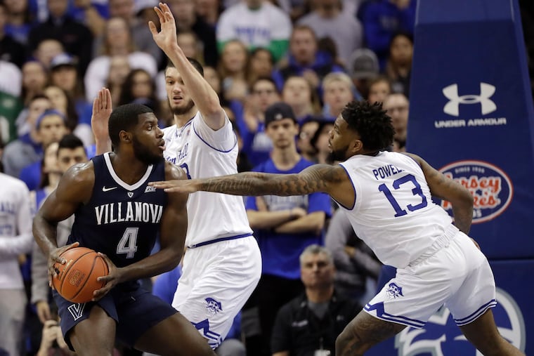 Eric Paschall (left) tries to get past Seton Hall defenders Myles Powell and Sandro Mamukelashvili during the Wildcats' loss on Sunday.