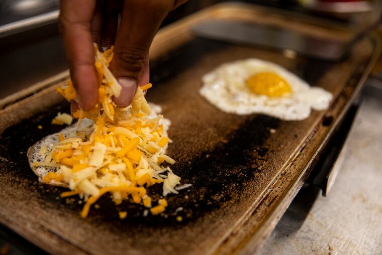 Salt and peppered sunny side up eggs cooking at Darnel’s Cakes at 444 North 3rd Street in Philadelphia, Pa., on Tuesday, June 14, 2022.
