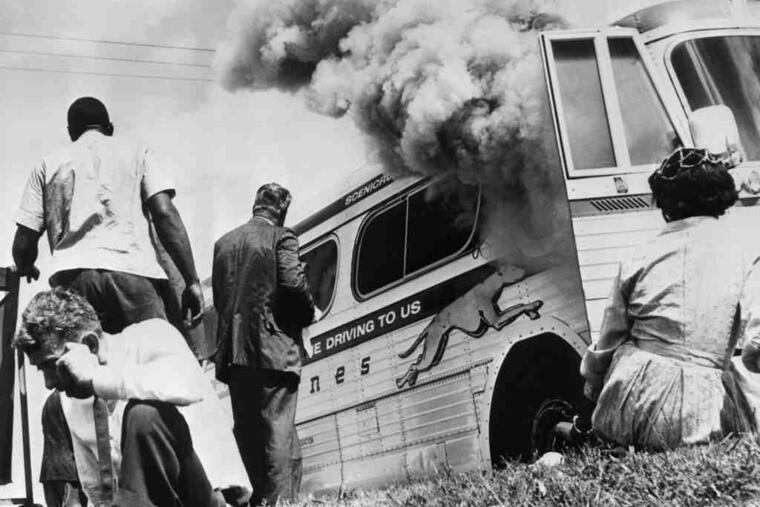 A Greyhound bus carrying Freedom Riders burns in Alabama after a white mob firebombed it on May 14, 1961.