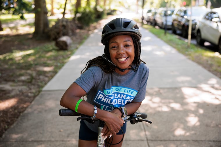 Evett Hawks posed for a portrait with her bike at Clark Park. Hawks, who has had two heart transplants, is competing this week in the Transplant Games of America.