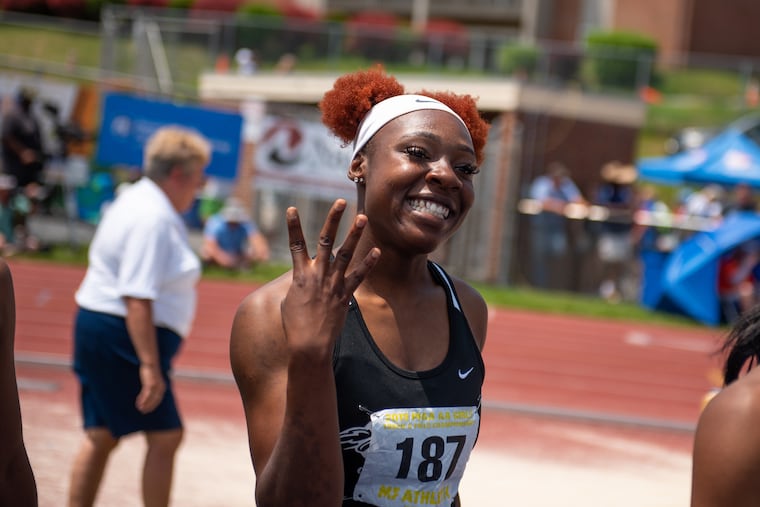 Thelma Davies from Girard College holds up her fingers after taking first in the girls Class 3A 100m dash for the fourth year in a row at the PIAA State Track and Field Championships at Shippensburg University on Saturday, May 25, 2019. KRISTON JAE BETHEL / For The Inquirer