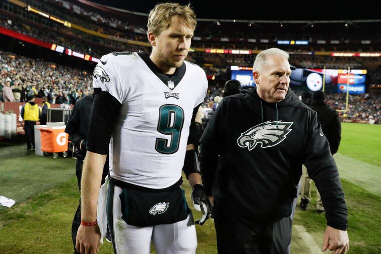 Eagles quarterback Nick Foles leaves the game with a team official during the fourth-quarter against Washington on Sunday, December 30, 2018 in Landover, MD.