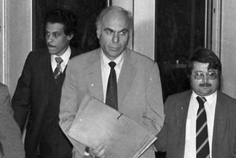 FILE - In this Jan. 22, 1983 file photo, ex-CIA agent Edwin Wilson, center, leaves federal court after a day of jury selection accompanied by U.S. Marshals in Houston. Edwin P. Wilson, a former CIA operative who was branded a traitor and convicted of shipping arms to Libya but whose conviction was later overturned after he served 22 years in prison, has died, Sept. 10, 2012. He was 84. (AP Photo/File)