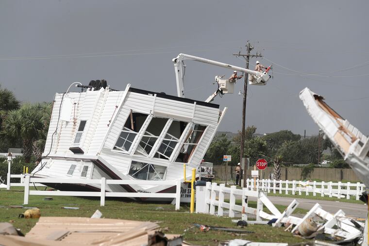 Power company lineman work to restore power after a tornado hit Emerald Isle N.C. as Hurricane Dorian moved up the East coast on Thursday, Sept. 5, 2018.