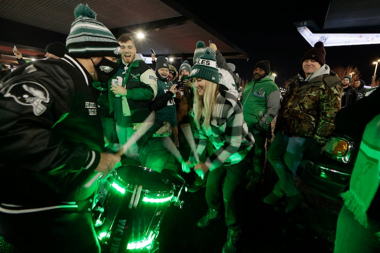 Eagles fan Emilee Ryan, of Lancaster, plays the drums with the Eagles drum line in the parking lot before Saturday night's game against the Cowboys at the Linc.