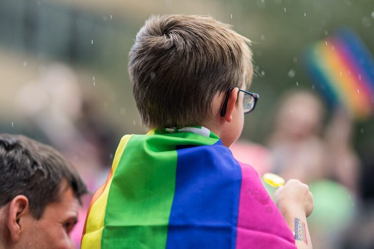 Toronto, Canada – July 3, 2016: A child wears a rainbow flag in support of LGBTQ rights.