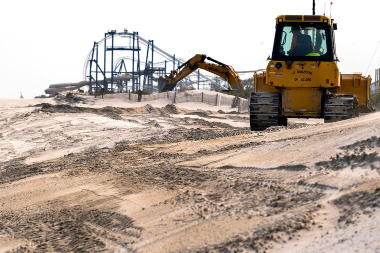 Work continues on an eroded section of beach in North Wildwood Tuesday, May 23, 2023. The Shore town received emergency permission from state officials to repair damaged dunes before the Memorial Day weekend. The crowds are about to return, although the unofficial start of summer will start off with a chill.