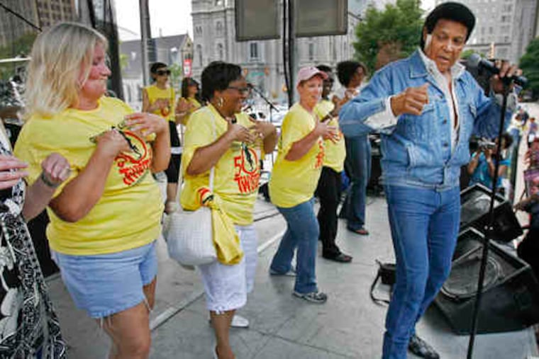 Celebrating the Twist's 50th, dancers join Chubby Checker onstage. "When I was young, we twisted the night away," a fan said.