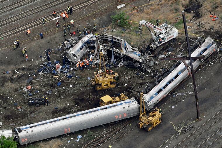 In this May 13, 2015, file photo, emergency personnel work at the scene of a deadly train derailment in Philadelphia.