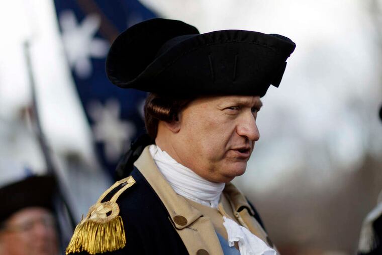 PHOTOS: MEL EVANS / STAFF PHOTOGRAPHER Gen. George Washington , played by John Godzieba, readies himself to cross the Delaware River yesterday, in the 62nd annual re-enactment of the boat trip that turned the tide of the Revolutionary War.