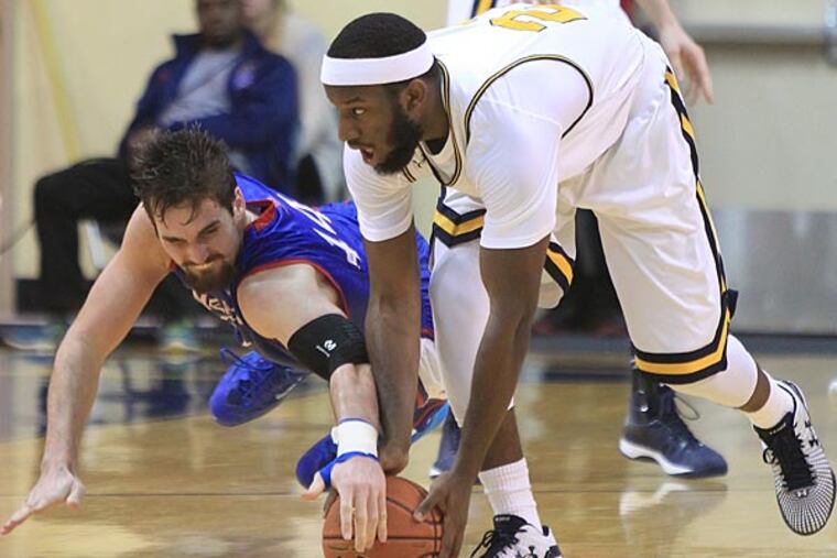American's Zach Elcano (left) and La Salle's Jordan Price go after a loose ball. (Charles Fox/Staff Photographer)