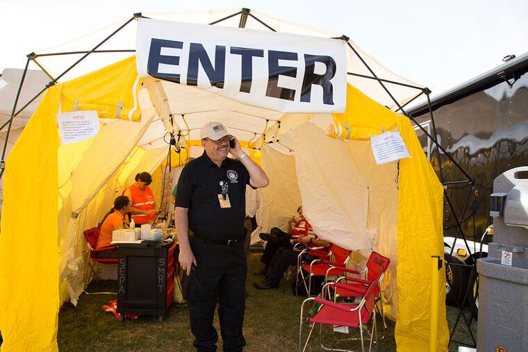 popemedtent26P, September 25, 2015 Tom Grace of SEPA-Smart styands at the entry way of the Pop-Up Medical Tent set up on the Parkway