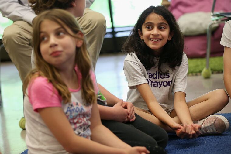 Germantown Friends School student Rania Raj, 8, right, talks about how something made her feel during a Feedback program session in her third-grade class.