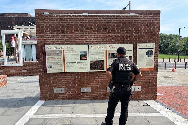 U.S. Park Police roam the site of the President's House after the Trump administration switched the panels overnight.