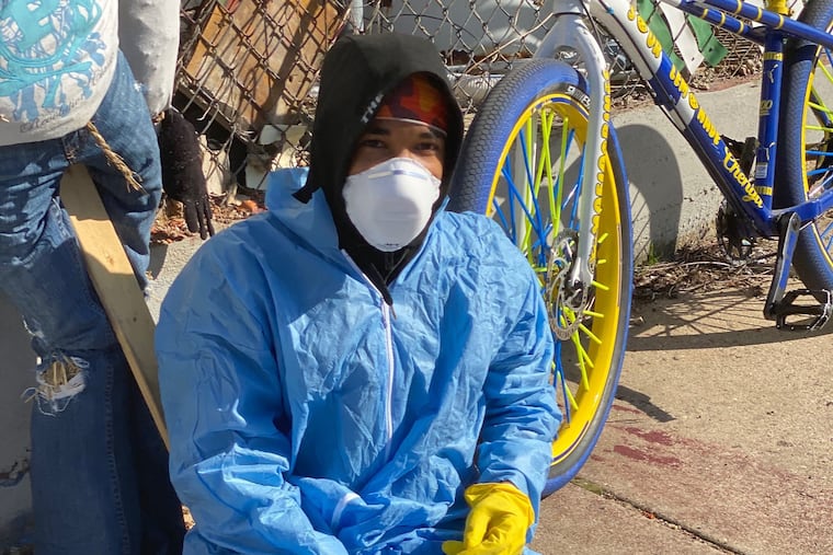 @BikeLifeRex, photographed here, went viral after posting a video a few weeks ago of himself dressed in medical-grade gear, spraying Lysol while standing on his bike and riding through North Philly.
