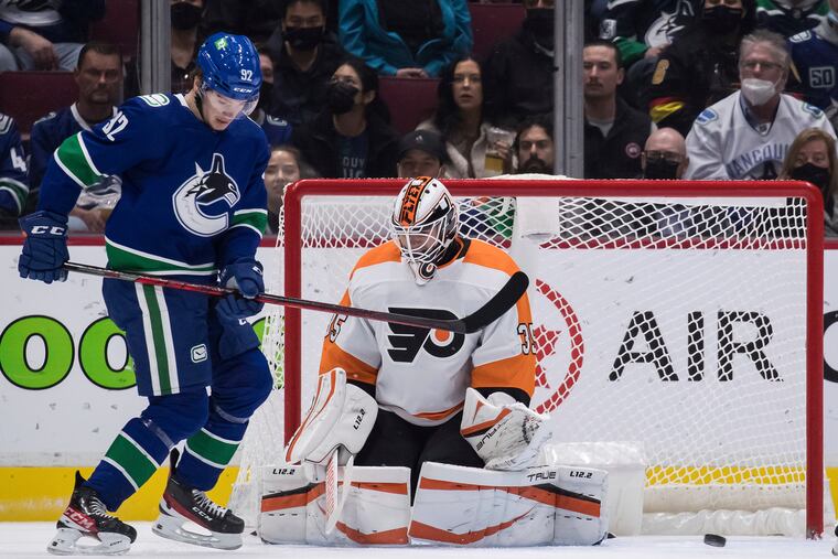 Flyers goalie Martin Jones makes a save as Vancouver Canucks' Vasily Podkolzin stands in front of him during the first period Thursday. The Flyers won, 2-1.