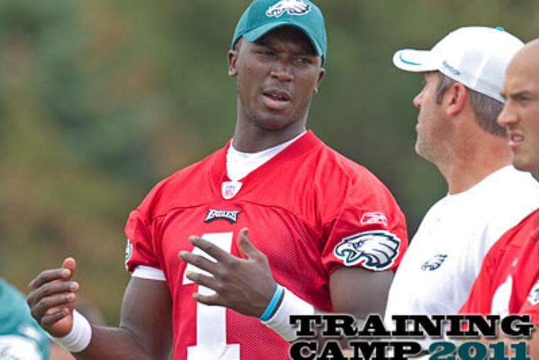 Eagles' backup quarterback Jerrod Johnson talks with QB coach Doug Peterson at training camp. (Ed Hille/Staff Photographer)