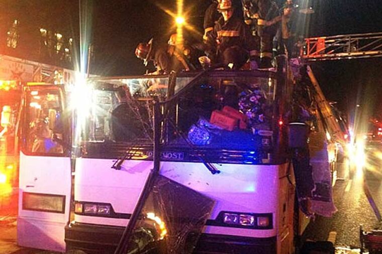 In this photo released by the Boston Fire Department via Twitter, firemen work to remove injured passengers from a bus that hit an bridge as it traveled along Soldiers Field Road in the Allston neighborhood of Boston Saturday night, Feb. 2, 2013. Officials said the bus carryinyg 42 people was traveling from Harvard University home to Pennsylvania when it struck the overpass. (Boston Fire Department/AP)