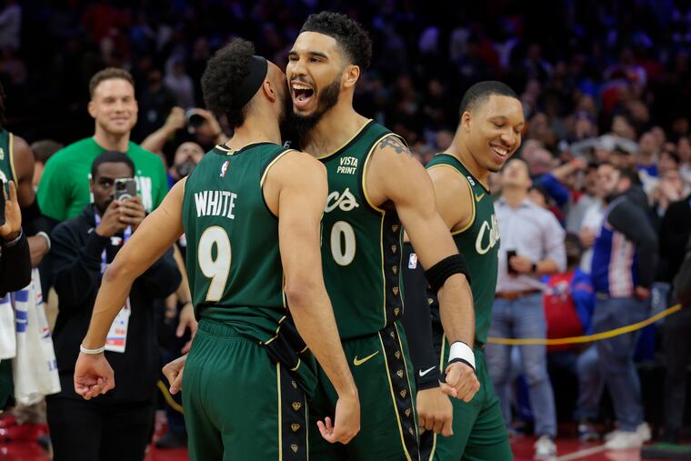 Jayson Tatum (center) of the Celtics celebrates with Derrick White (left) after Tatum's game-winning basket during their game at the Wells Fargo Center on Feb. 25, 2023.