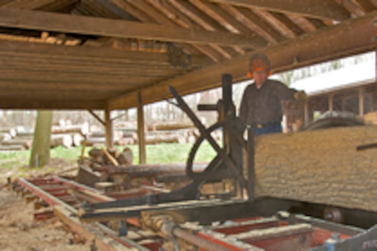 David Spacht in his sawmill. Spacht, who sells most of his sawdust to horse farms for bedding, says he has not raised his prices because he still feels fortunate to be able to get rid of it.