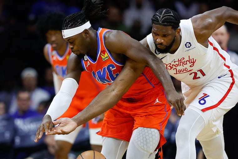 Sixers center Joel Embiid fouls Oklahoma City Thunder guard Luguentz Dort in the first quarter on Thursday, January 12, 2023 in Philadelphia.