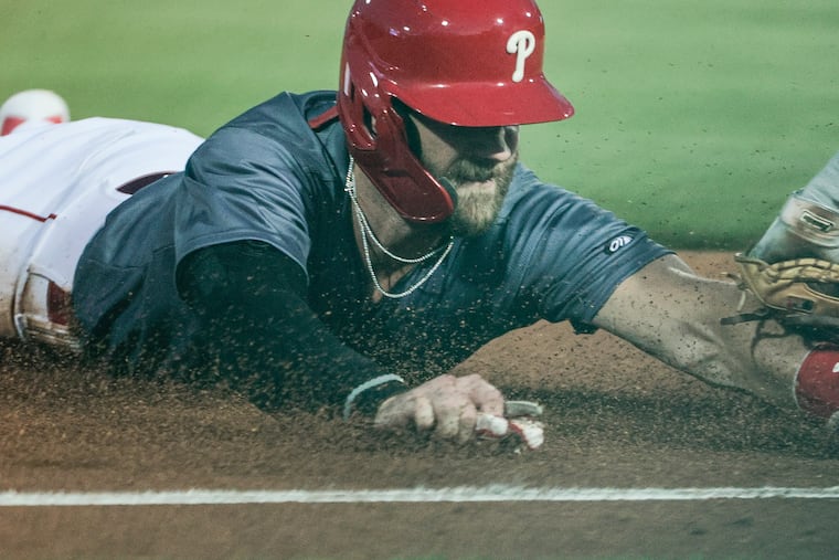 Bryce Harper tries stealing third base but is tagged out by Stripers third baseman Rylan Bannon during the third inning in Allentown, Tues. Aug. 23, 2022.