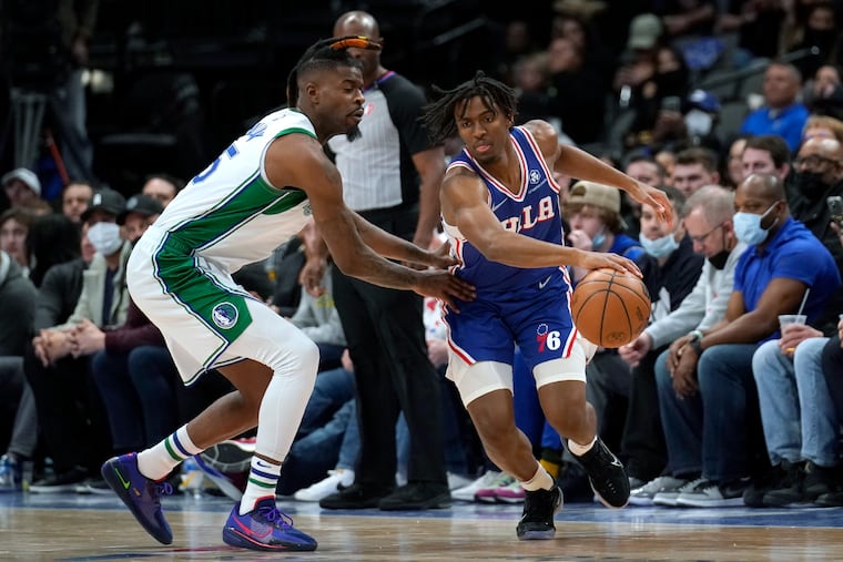 Dallas Mavericks' Reggie Bullock (left) defends against Philadelphia 76ers guard Tyrese Maxey during the first half of an NBA basketball game in Dallas, Friday, Feb. 4, 2022.