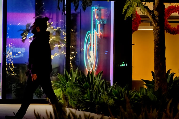 A neon TikTok logo hangs in the lobby of the TikTok office building in Culver City, Calif., on Tuesday, Dec. 3, 2024.