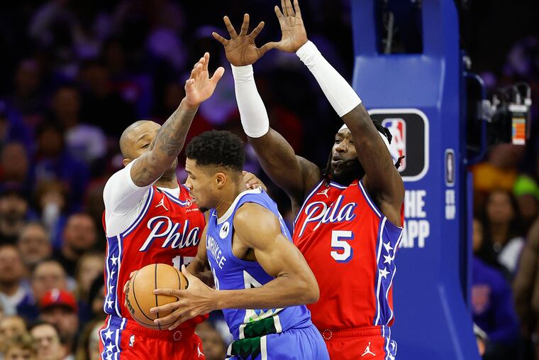 Sixers forward's P.J. Tucker and teammate Montrezl Harrell defend Milwaukee Bucks forward Giannis Antetokounmpo on Friday, November 18, 2022 in Philadelphia.
