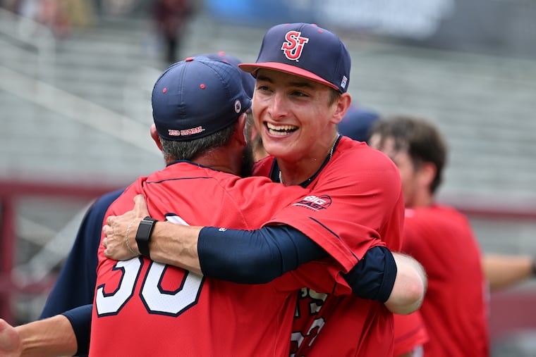 St. John's pitcher Liam O'Leary hugs his coach. He is the starting pitcher Saturday night in the NCAA super regionals against host Alabama.